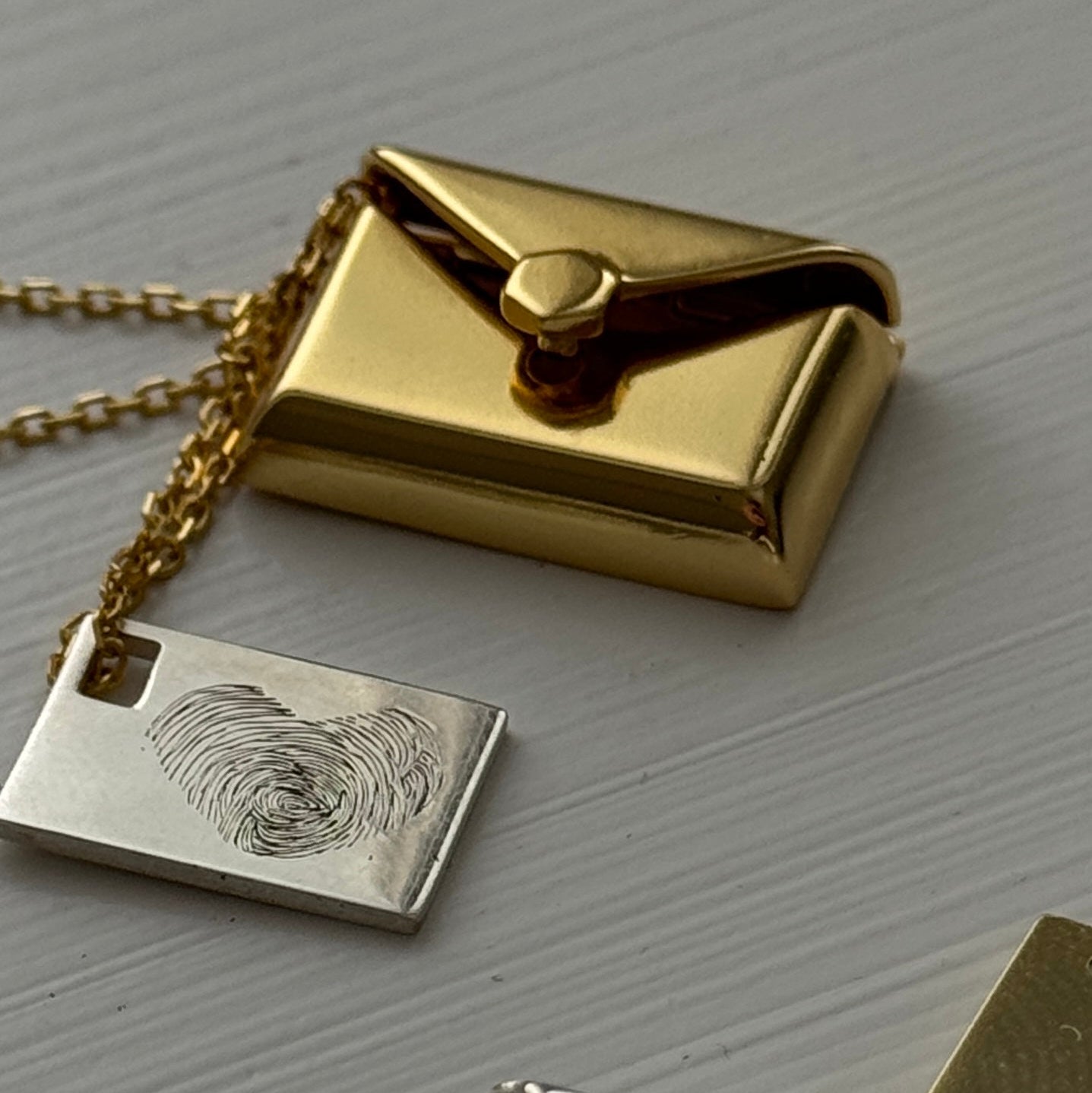 Maelle envelope necklace with hidden letter charm, engraved with personalized message, handwriting, paw print, or fingerprint.