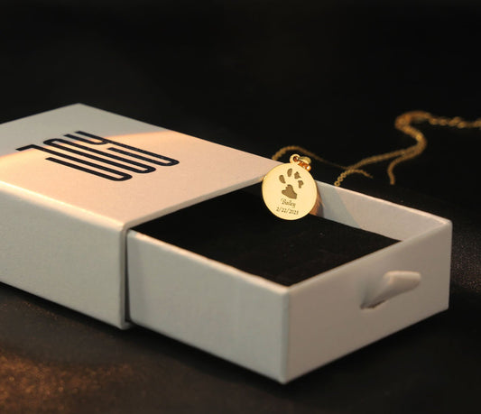 The Bailey Necklace engraved with custom dog paw print in gold plated.