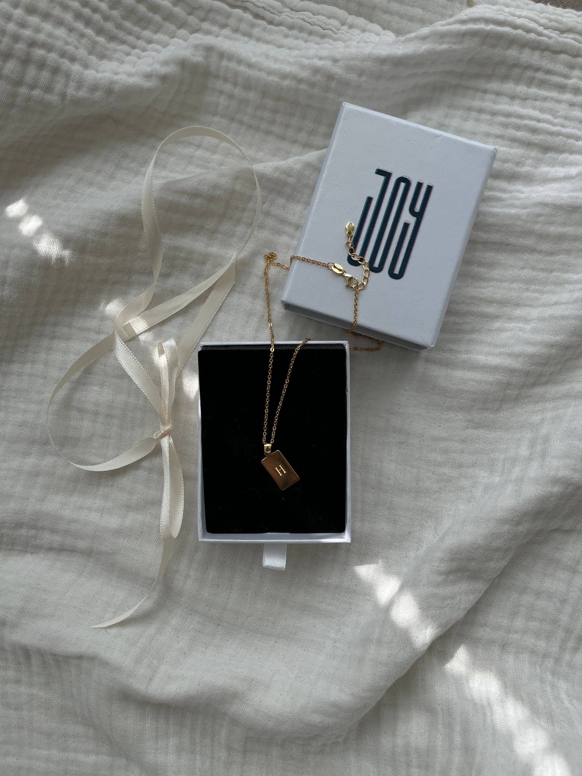 Personalized rectangular pendant engraved with initial