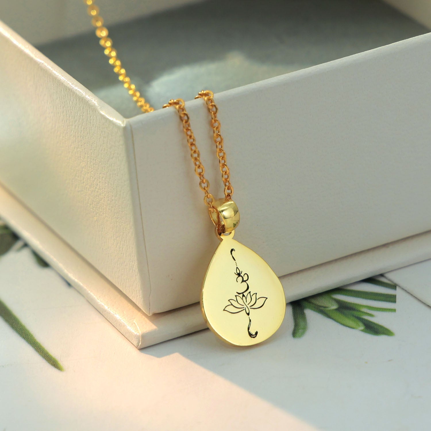 Rose pendant is sterling silver and gold plated with OM and lotus engraving in black
