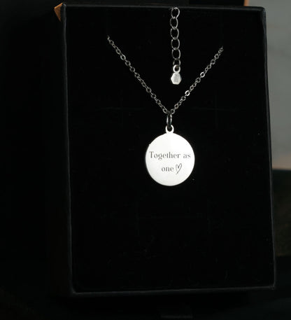 Back view of round sterling silver pendant engraved with custom message