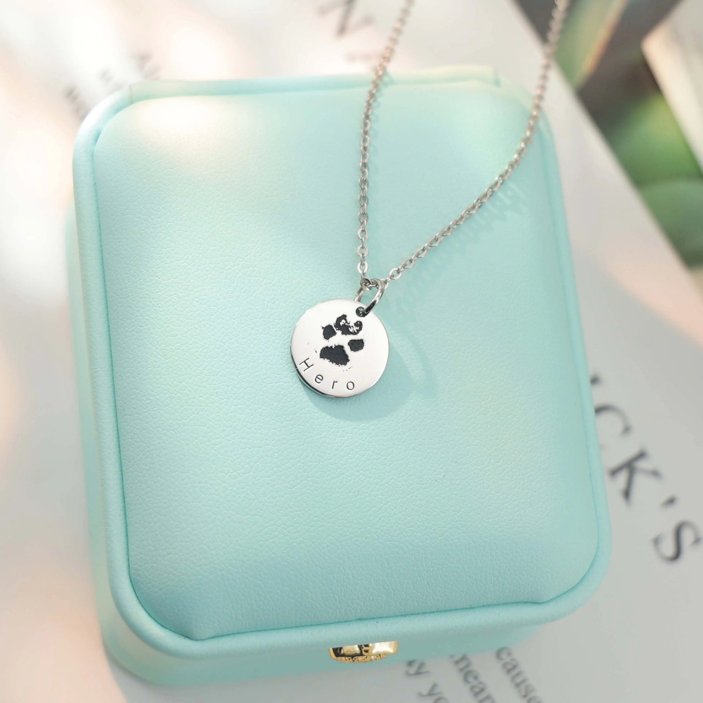 White gold–plated silver pendant engraved with a custom paw or nose print, personalized pet keepsake necklace.
