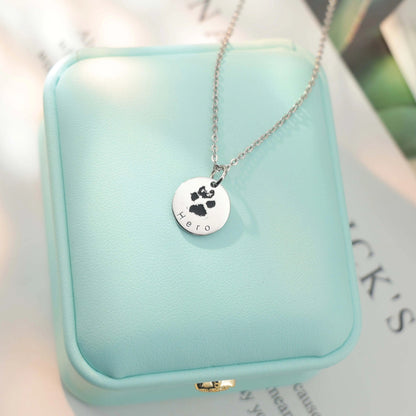 White gold–plated silver pendant engraved with a custom paw or nose print, personalized pet keepsake necklace.